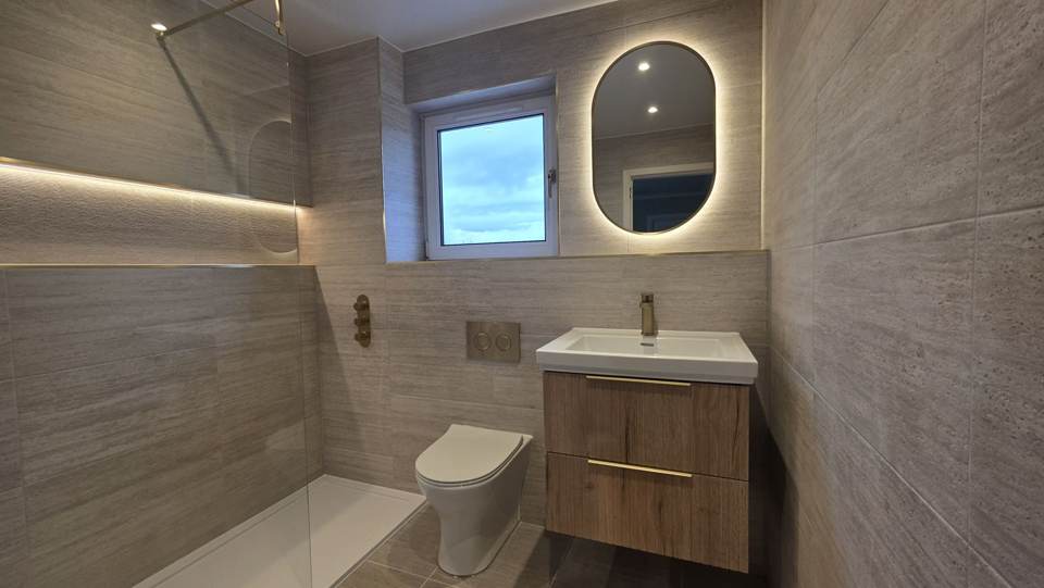 Finished main bathroom in Bearsden with walk-in shower and LED oval mirror